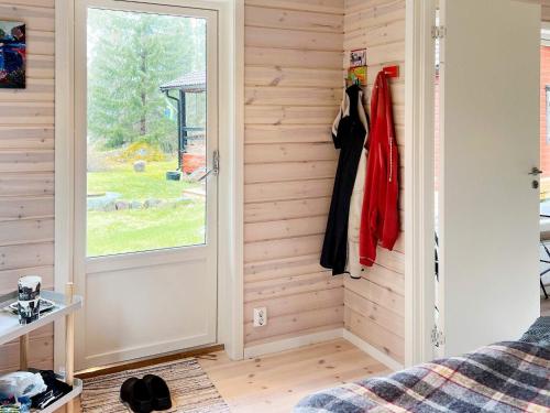 a bedroom with a door and a window at 4 star holiday home in VäTö in Vätö