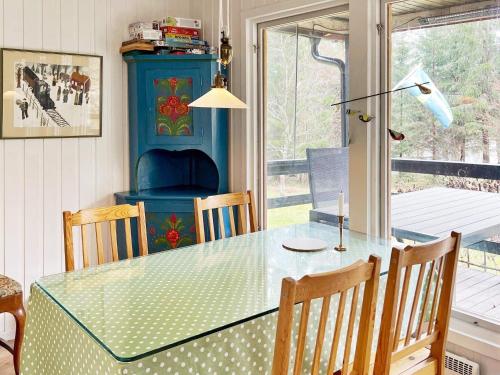 a dining room with a glass table and chairs at 4 star holiday home in VäTö in Vätö