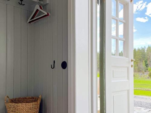 a door leading to a porch with a wicker basket at 4 star holiday home in Mellösa-By Traum in Mellösa