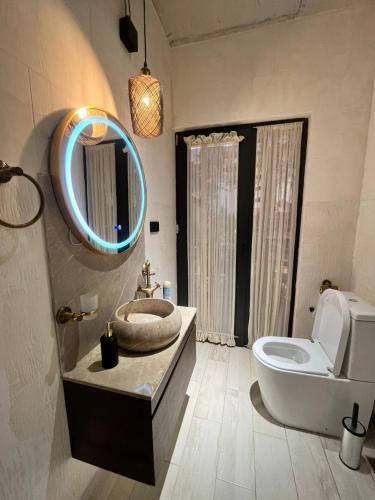 a bathroom with a sink and a toilet and a mirror at Grigoleti Dream House in Grigoleti
