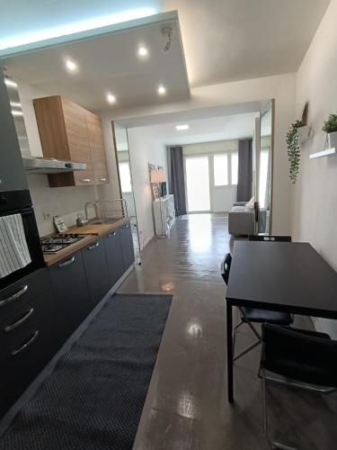 a kitchen and living room with a table and a stove at Monolocale Farina in Cagliari