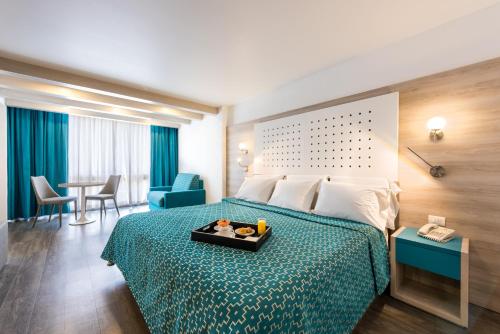 a hotel room with a bed with a tray of food on it at Hotel Casa Blanca in Mexico City