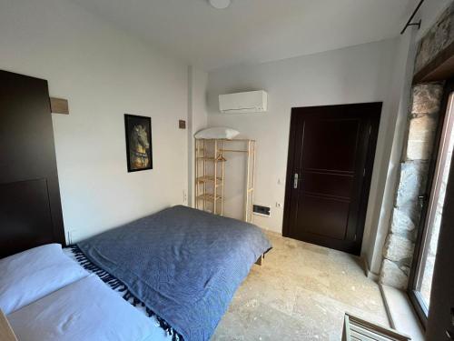 a bedroom with a bed in the corner of a room at AGON Ephesus in Selcuk