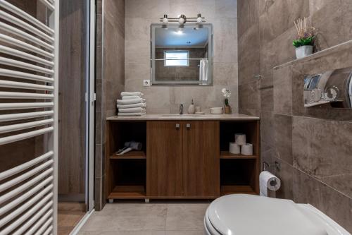 a bathroom with a sink and a mirror at Salt Orchid Central in Turda