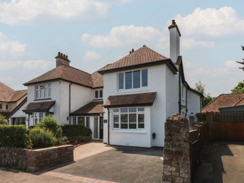 a large white house with a garage at Wendy's Cottage in Minehead
