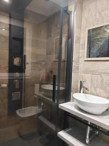 a bathroom with two sinks and a glass shower at Blu Etna Casa Vacanze in Zafferana Etnea