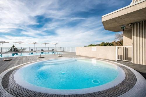 a swimming pool on the roof of a building at Green Cape Botanico in Batumi