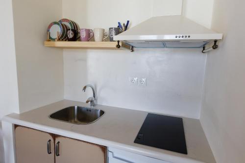 a kitchen with a sink and a counter top at Ligaries in Kinion