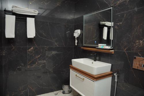 a bathroom with a sink and a mirror at MyHotel Erbil in Erbil