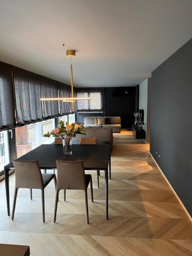 a dining room with a table and chairs and a living room at Fiorini Rooms Sora in Sora
