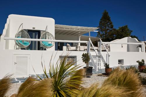 a white house with plants in front of it at Sand Lily Villa Mykonos in Mýkonos City