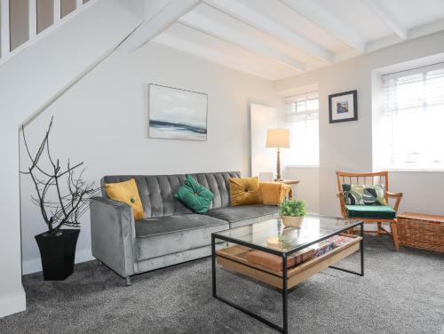 a living room with a couch and a coffee table at Ty Bara in Cemaes Bay