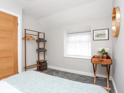 a bedroom with a bed and a window at Ty Bara in Cemaes Bay