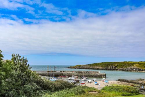 a group of boats sitting on the beach at Ty Bara in Cemaes Bay