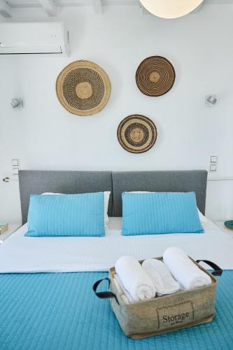 a room with a bed with a basket of towels at Sand Lily Villa Mykonos in Mýkonos City