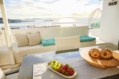 a table with a bowl of fruit on a yacht at Sand Lily Villa Mykonos in Mikonos