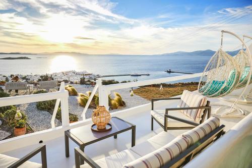 a balcony with a hammock and a view of the ocean at Sand Lily Villa Mykonos in Mýkonos City
