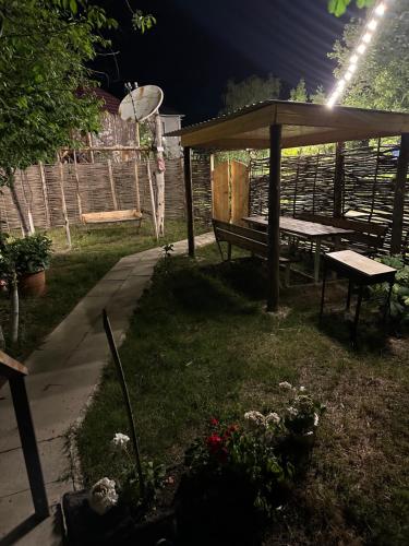 a picnic table and a bench in a garden at night at A-Frame Qusar in Qusar