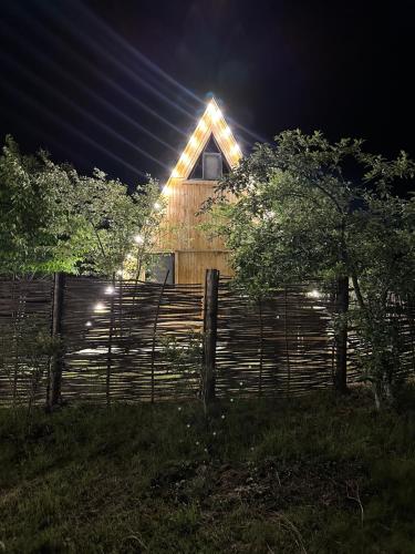 a house with lights on the side of a fence at A-Frame Qusar in Qusar