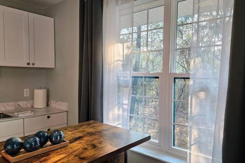 a kitchen with a table and a large window at The Hideaway - Centrally located between Crystal River & Inverness in Lecanto