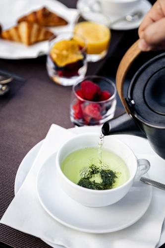 a person pouring a bowl of soup on a table at Bdesign & Spa in Paradou