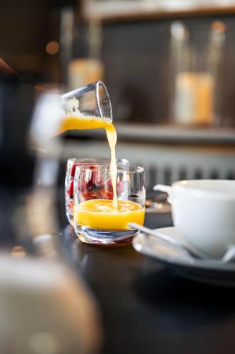 a glass bowl filled with orange juice on a table at Bdesign & Spa in Paradou
