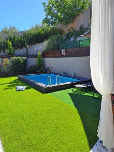 a swimming pool in the middle of a yard at Ideal House with Private Pool & Parking in Heraklio Town