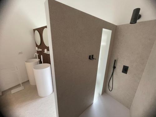a bathroom with two sinks and a mirror at Giardini di Luce in Matera