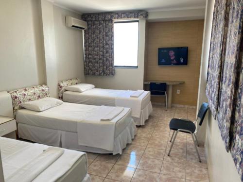 Un pat sau paturi într-o cameră la Águas Palace Hotel