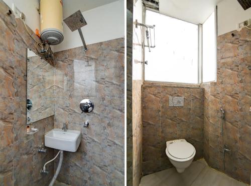 a bathroom with a toilet and a sink at Hotel Q Inn in Kolkata
