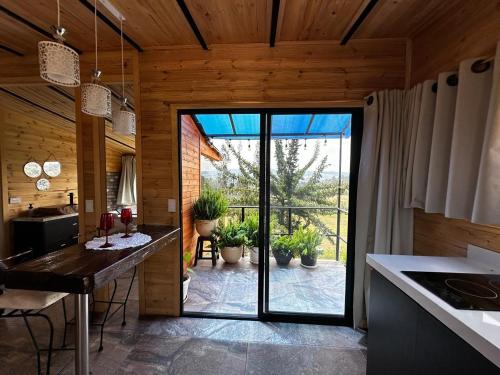 a kitchen with a large glass door leading to a patio at Entre hayuelos in Iza