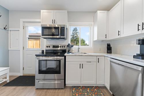 a kitchen with white cabinets and stainless steel appliances at The Garden Retreat in Welland, On - 1BR,Free Parking and Workspace in Welland