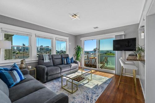 a living room with a couch and a tv at Bankers Hill Hideaway with AC Views and Parking in San Diego