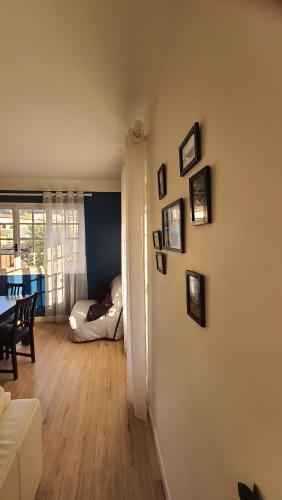 a living room with a white couch and a bedroom at chez steph in La Trinité