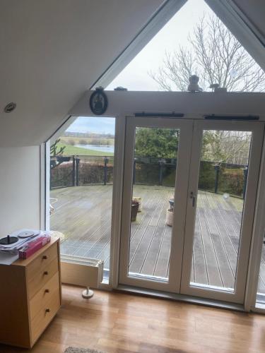 an extension to a house with sliding glass doors at Nedlagt Landbrug med 3 lejligheder in Vejle