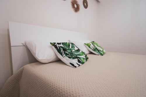 two pillows sitting on top of a bed at Macramè Room in Bari