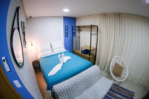 ein Schlafzimmer mit einem Bett mit einem weißen Kaninchen darauf in der Unterkunft Maracaipe Estrela Flat110 in Porto De Galinhas