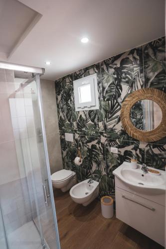 a bathroom with a toilet and a sink and a mirror at Macramè Room in Bari