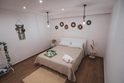 a white bedroom with a bed with two pillows on it at Macramè Room in Bari