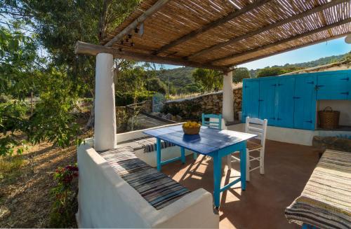 a blue table and chairs on a patio at Annas Katikia in Drymonas