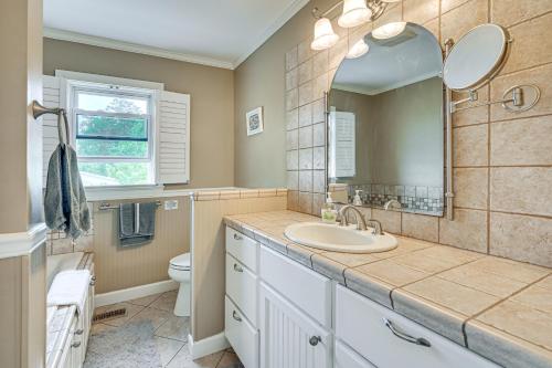 a bathroom with a sink and a mirror at Pamlico River House with Private Dock and River View! in Washington