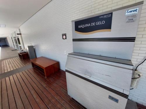 a room with two drawers and a sign on the wall at Book Santos - Unlimited 1608 Panorâmico c/ 3 dorm in Santos