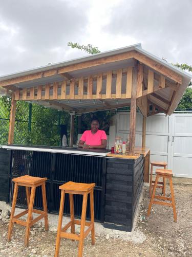 a woman standing at a bar with a roof over it at POSADA MISS ANIBEL in San Andrés