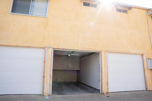 two garage doors are open on a building at 1 Block from Beach - Steps from Restaurants & Shops in Oceanside