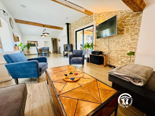 a living room with a couch and a table at Domaine de Gazel in Laure-Minervois