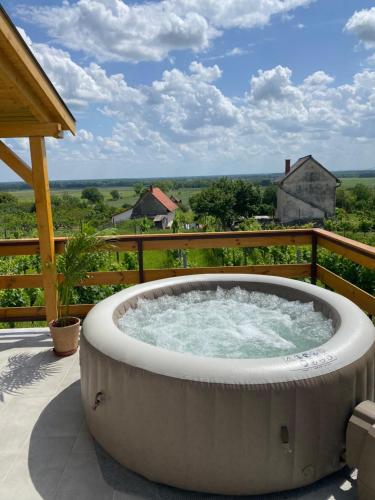 a large hot tub on a patio with a view at Alma Apartmanház in Harkány