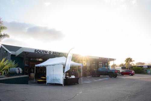 a tent in front of a building with a truck at 1 Block from Beach - Steps from Restaurants & Shops in Oceanside