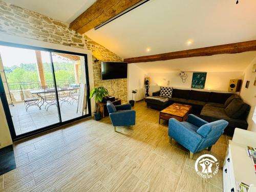 a living room with a couch and chairs and a table at Domaine de Gazel in Laure-Minervois