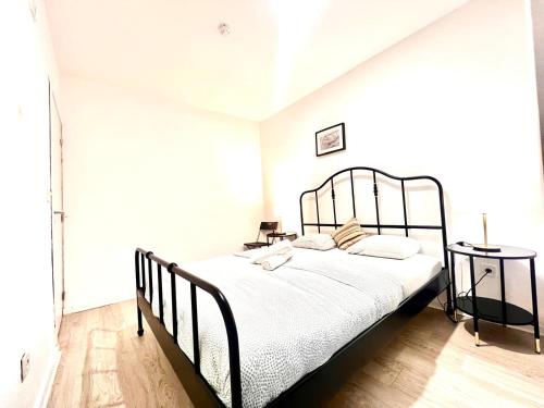 a bedroom with a bed with a metal frame at SwissPorto Guest House in Porto