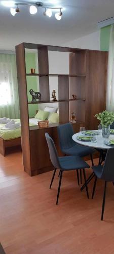 a room with a table and chairs and a bed at ANTONIJ Apartment Gevgelija in Gevgelija